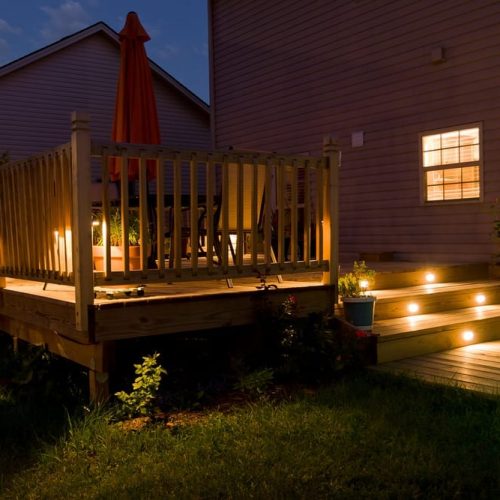 Wooden,Deck,And,Patio,Of,Family,Home,At,Night.